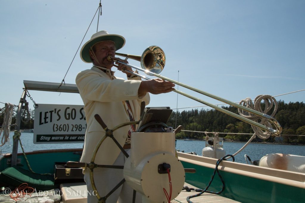 David Howitt at the wheel playing the tombone