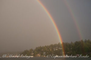 Sailing under double rainbow to find the 2 pots of gold at the ends
