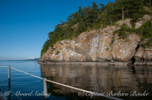 Sailing passed Flattop Island with reflections and evening light