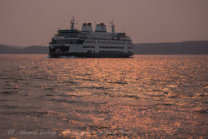 WA state Ferry in sun streak